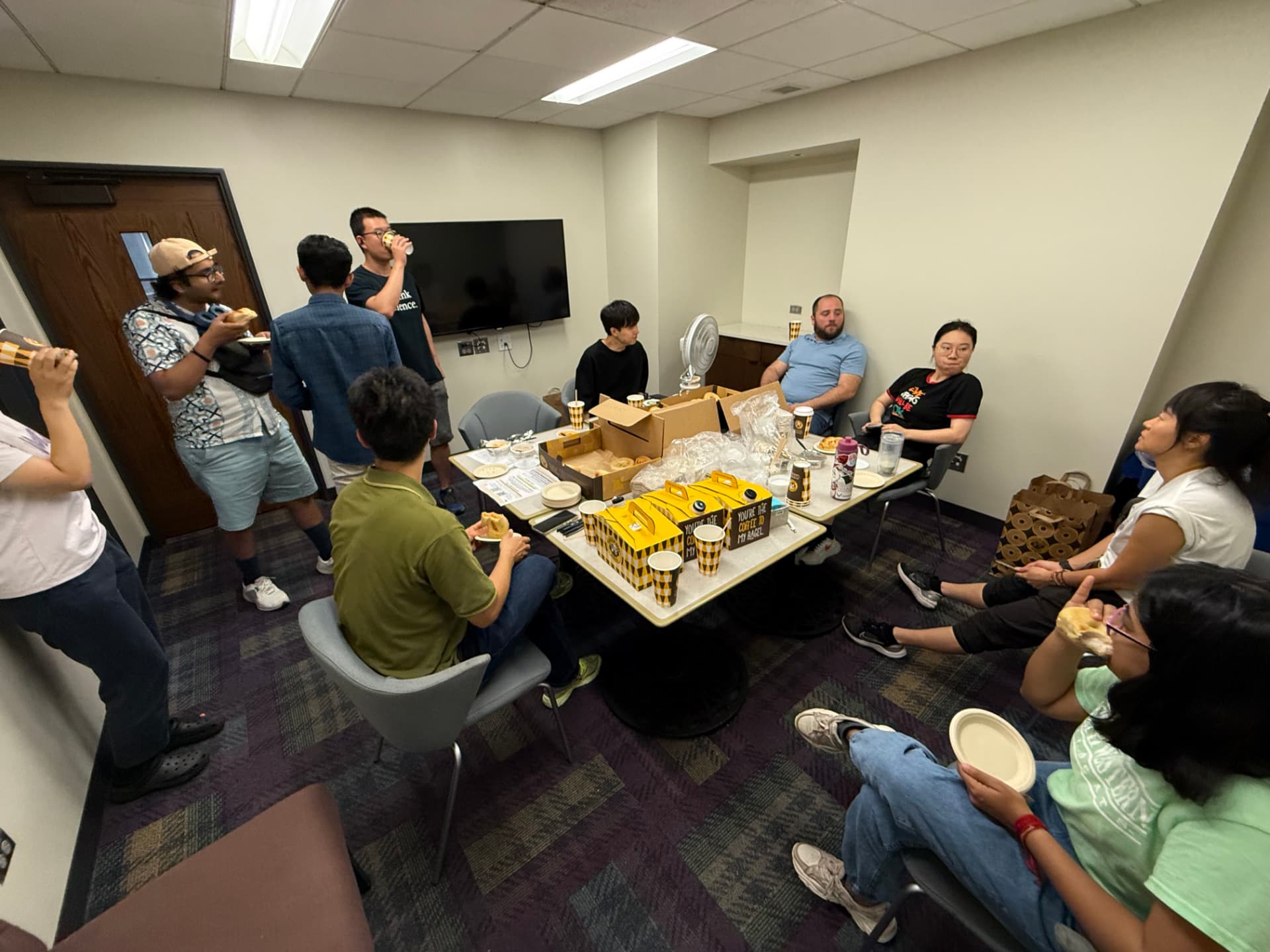 Graduate students chatting over bagels and coffee at the Evanston campus Bagel Mingle